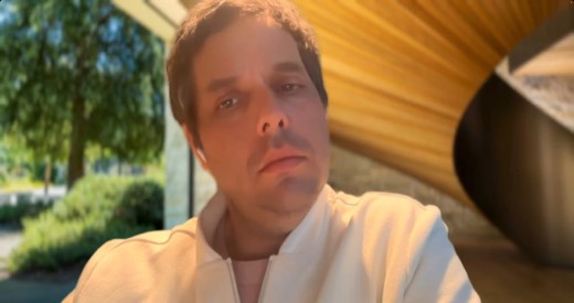 Tony Jones webcam, outdoors, hand near chin