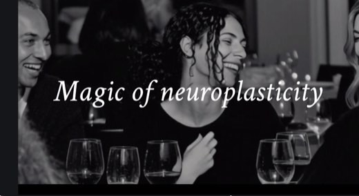 Black and white AI-generated slide reading "Magic of neuroplasticity" over a photo of people smiling and laughing at a table with wine glasses.