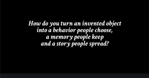 Sharon's slide, black background, italic white text: "How do you turn an invented object into a behavior people choose, a memory people keep and a...